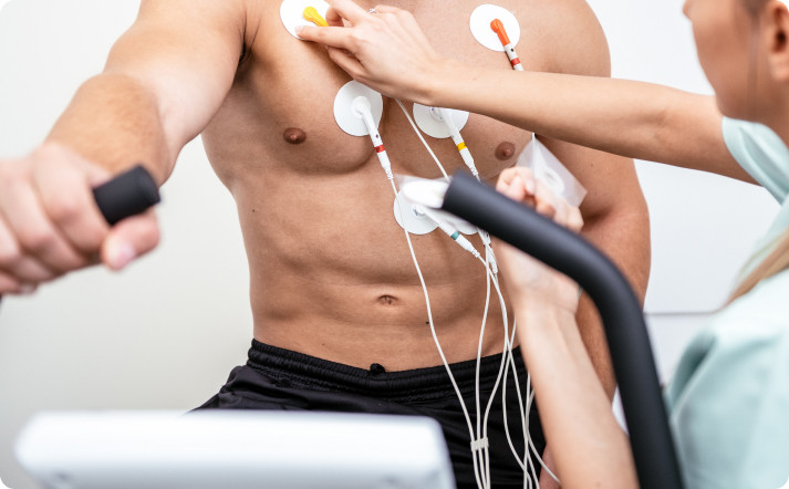 Man on a treadmill with chest electrodes, prepared for Cardiac Stress Testing